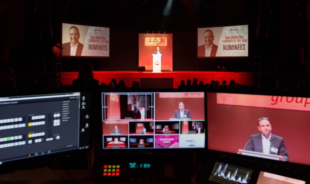 A presentation with three monitors
