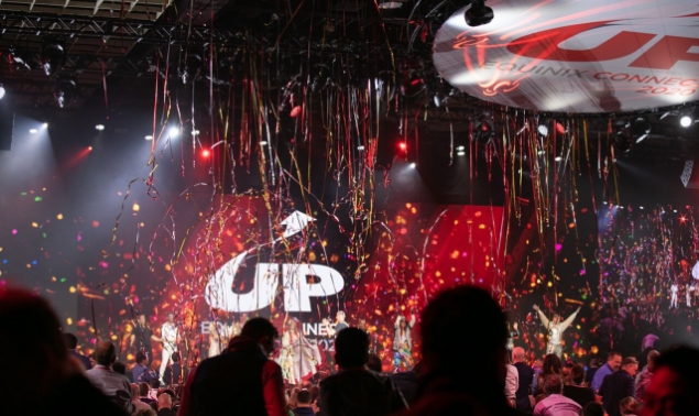 An event hall with audience cheering while confetti falls