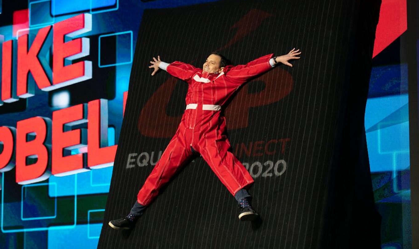 A man sticking at the wall playing a game