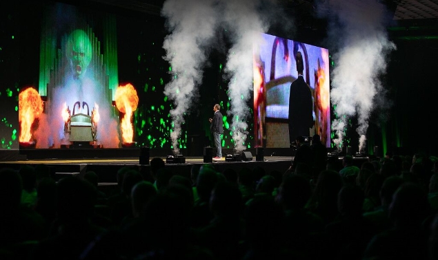A man in a suit giving a speech at a conference