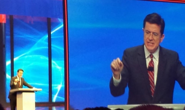 A man in a suit giving a speech at a conference