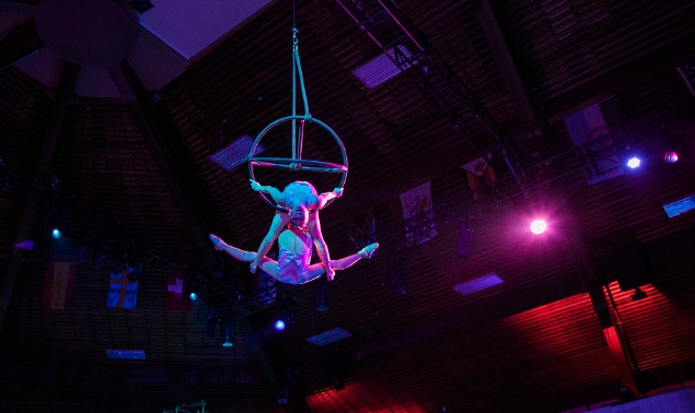 Two girls performing acrobatics in the air